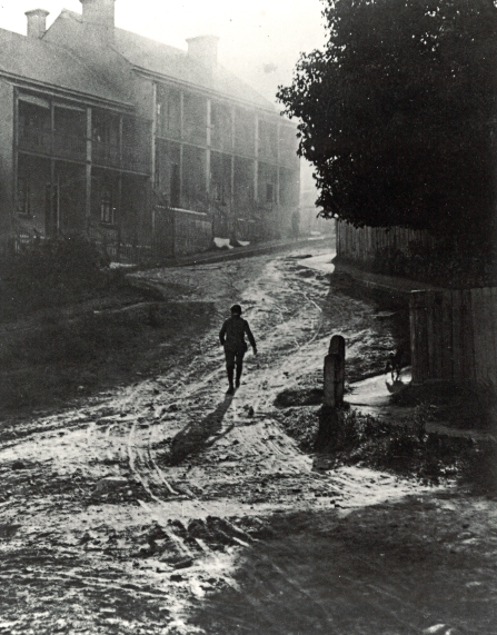 , Photographer Harold Cazneaux lived in Riley Street, North Sydney, in 1908 when this photograph 'Misty Morning, North Sydney' taken. It may indeed depict the photographer's street. Unsealed thoroughfares, such as this, must have made the upkeep of clean interiors extremely difficult. Council began sealing pavements with tar in the 1890s. Roads followed but some remained unsealed well into the 1950s. Courtesy of Sally Garrett. Stanton Library