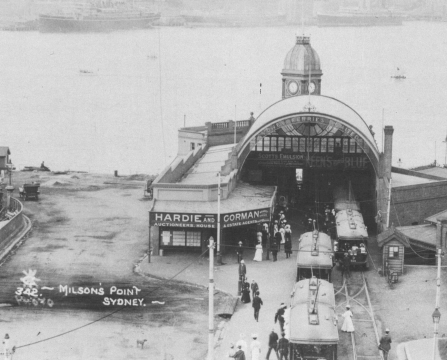 , The busy Milsons Point Ferry Arcade was a prime location for real estate agents Hardie and Gorman. Thousands of commuters and shoppers were funnelled through this building every week on their way to and from the ferries that connected both sides of the Harbour. Ongoing speculation about the possibility of a Harbour Bridge and the resulting improvement in access between North Sydney and the city kept interest in north shore dwellings high. A competition for Bridge designs was announced in 1900 around the time that this photograph was taken. Stanton Library